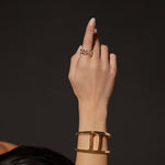 Classic Tri-Link with Diamond Bridges ring in 18K gold, shown with other pieces