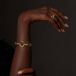 Quad Link with Diamond Bridges ring in 18K gold, shown with other pieces