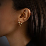 Micro Tri-Link Huggie with Diamonds earrings in 18K gold, worn on the ear